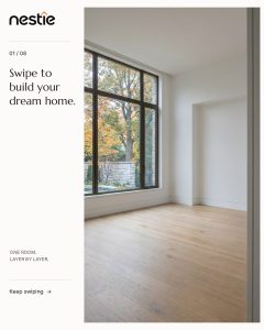 Modern minimalist room with large windows overlooking a garden, wooden floors, and white walls.