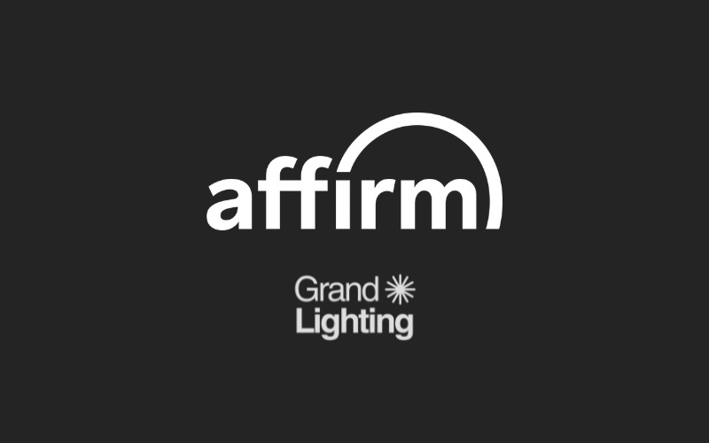 Affirm and Grand Lighting logos on a dark background, showcasing partnership in financial services and home lighting solutions.